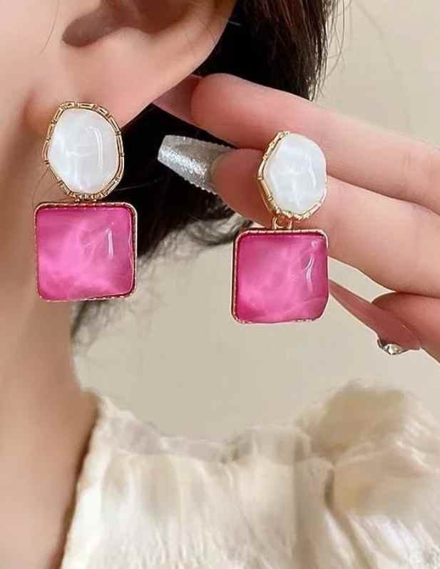 white and pink earrings